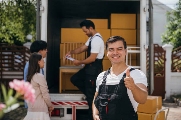 Movers handling a large home appliance during a relocation in the UAE