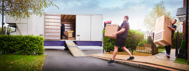 Movers loading boxes into a van outside an apartment tower in Al Nahda Sharjah