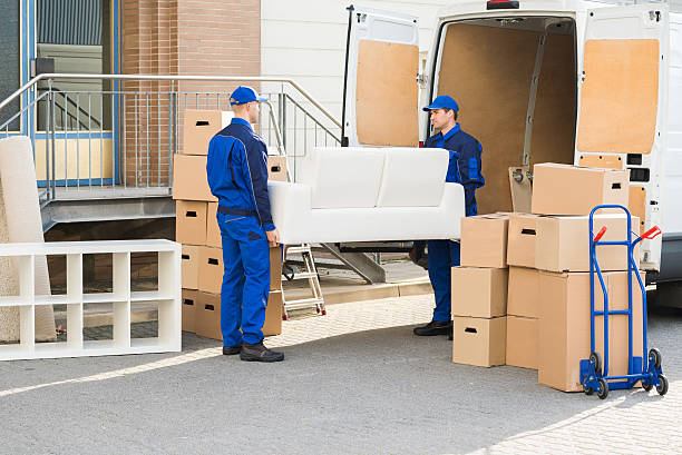 Mover carrying boxes down the stairs of an apartment building in Deira Dubai