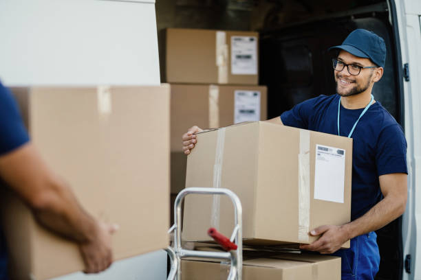 Mover checking an inventory list during a house move in Al Nakheel Ras Al Khaimah