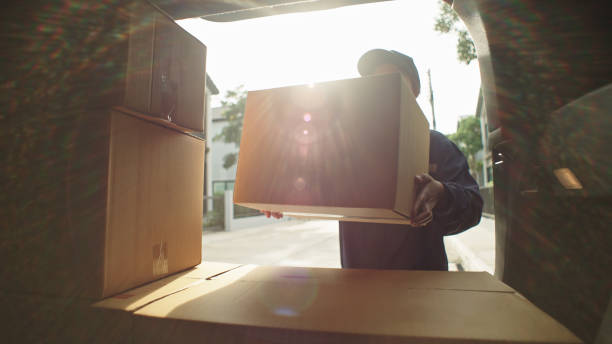 Sealing a moving box securely with packing tape before transport in Dubai